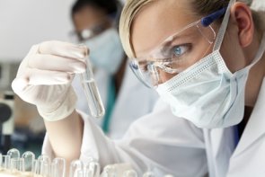 Female Scientific Research Team With Clear Solution In Laborator Female Scientific Research Team With Clear Solution In Laborator