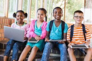 Portrait of kids using a laptop and digital tablet on stairs 112180100000017113.jpg