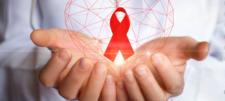 Ribbon for the fight against AIDS in the hands.