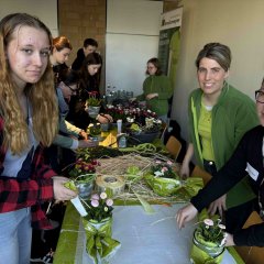 Drei Personen mit Blumen