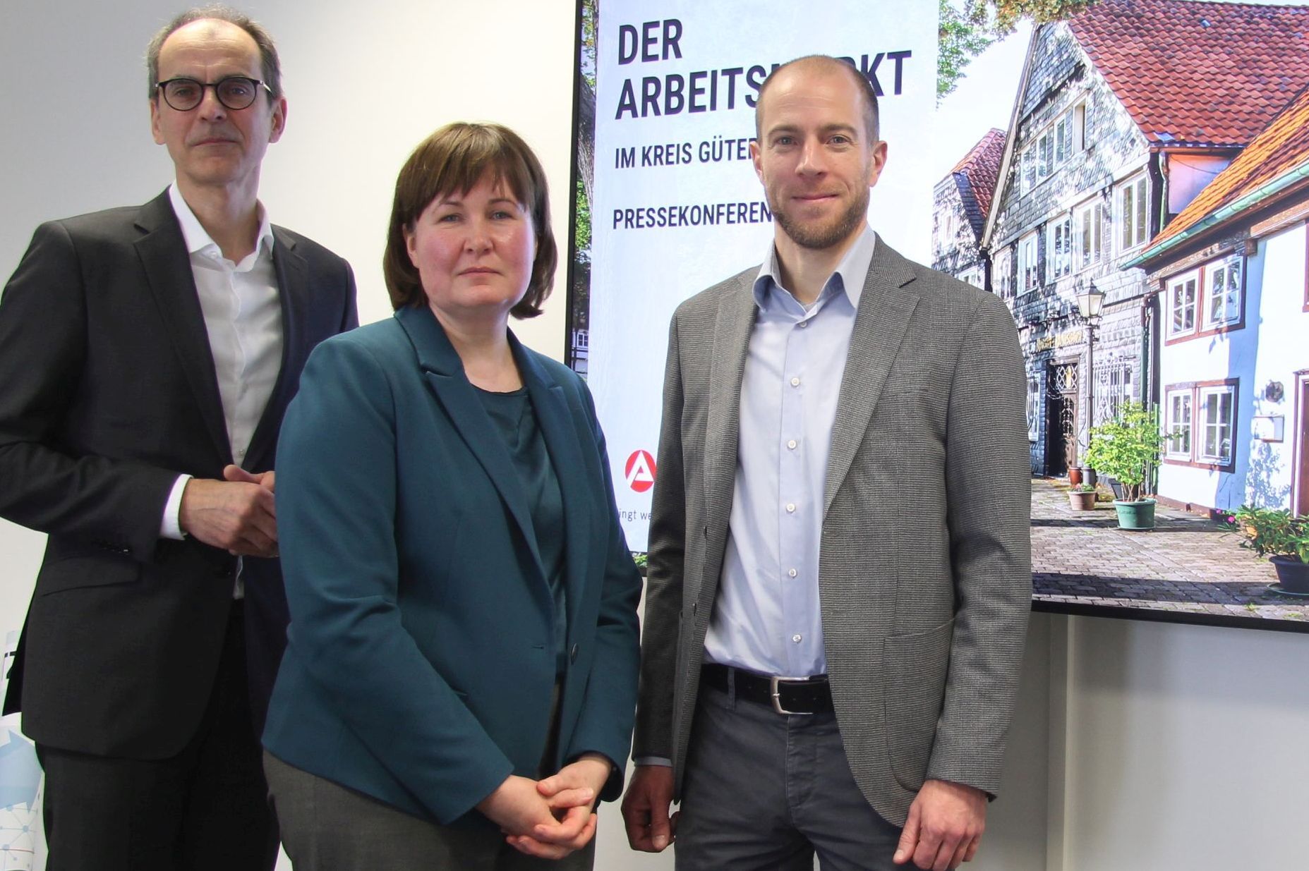 Wolfgang Draeger, Leiter der Agentur für Arbeit Bielefeld/Gütersloh, Kathrin Falke, Dezernentin des Jobcenters des Kreises Gütersloh, und Marc Traphöner, Gütersloher Geschäftsstellenleiter der Agentur für Arbeit, vor der Bildschirmpräsentation zur Jahrespressekonferenz der beiden Einrichtungen.