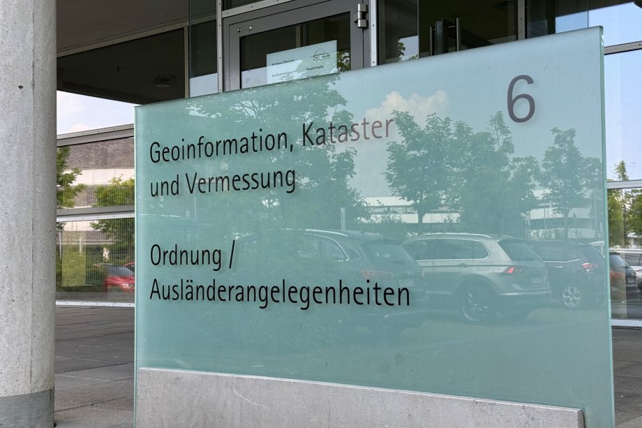 Glashinweisschild unter anderem zur Ausländerbehörde
