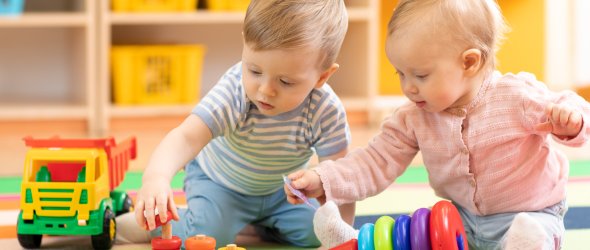 Preschool boy and girl playing on floor with educational toys. Children at home or daycare. Preschool boy and girl playing on floor with educational toys. Children at home or daycare.